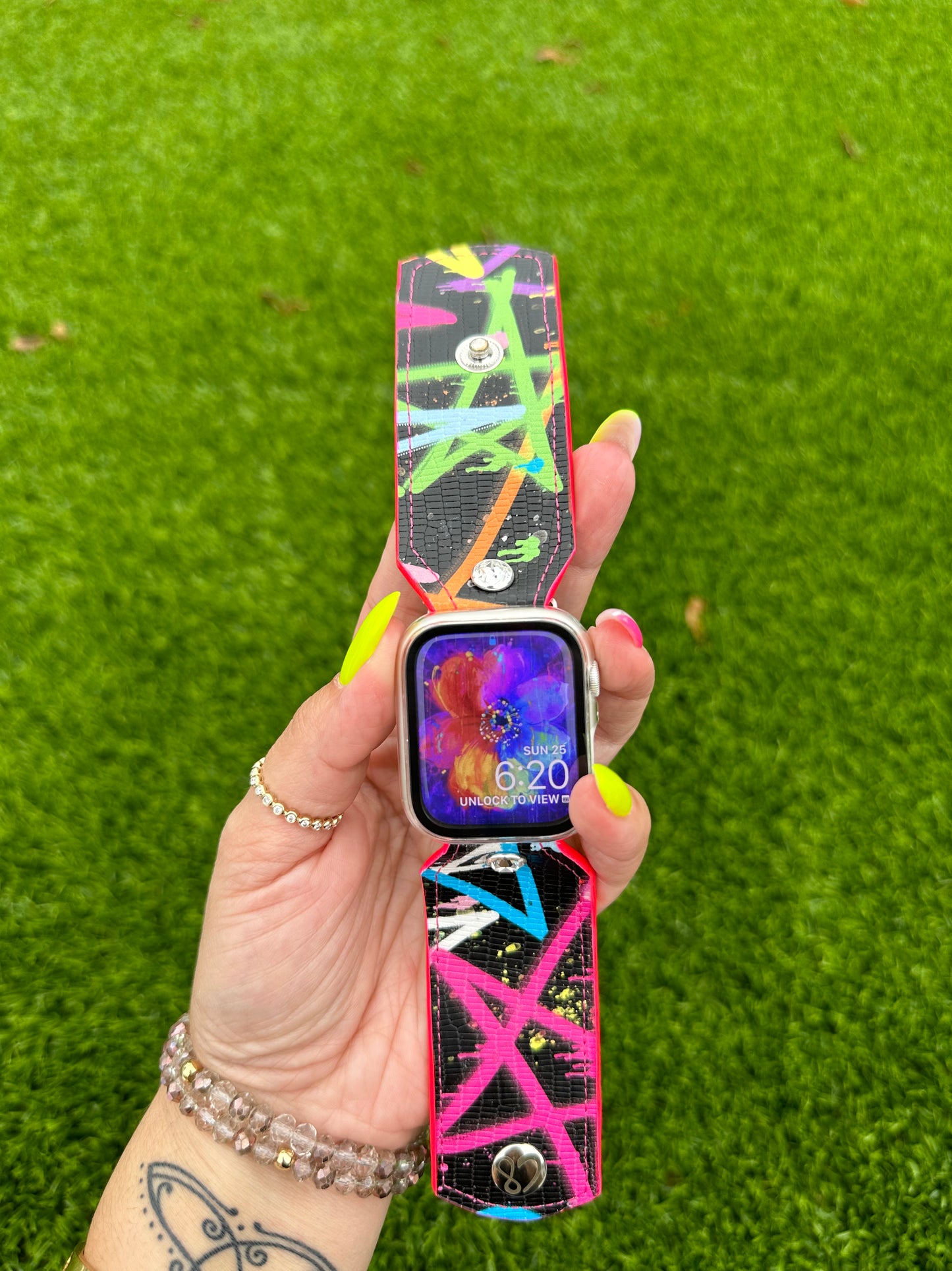 This is an authentic Besty Johnson band. It is made out of a faux leather material and lined with your choice of neon leather.