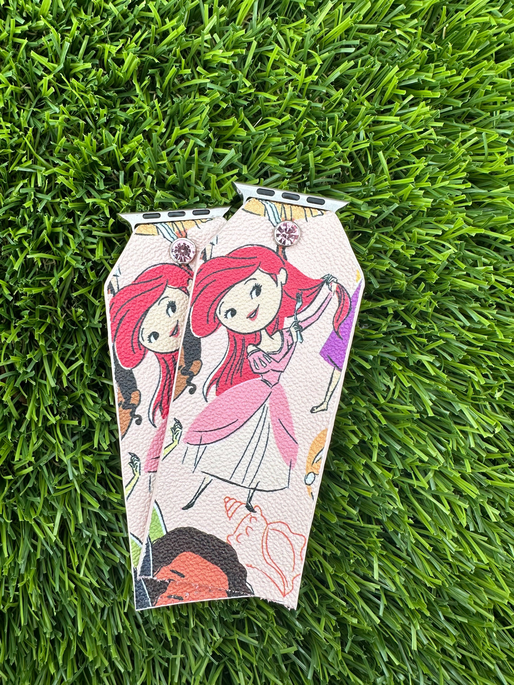 This is an authentic Dooney & Bourke band. It is made out of a coated canvas material and lined with a light metallic pink leather. The edge paint matches the background color of the band. The color of the crystals correlates with the corresponding princess.